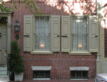 Brick home with functional raised-panel shutters