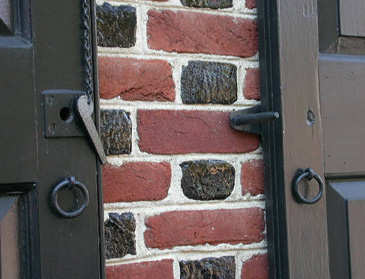 Forged ring and hardware on early brickwork