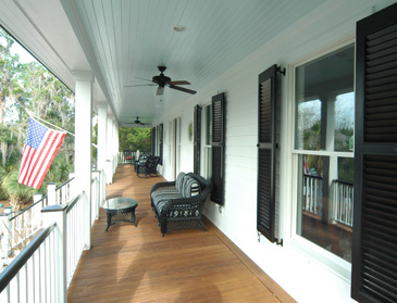 Porch lined with louvered shutters